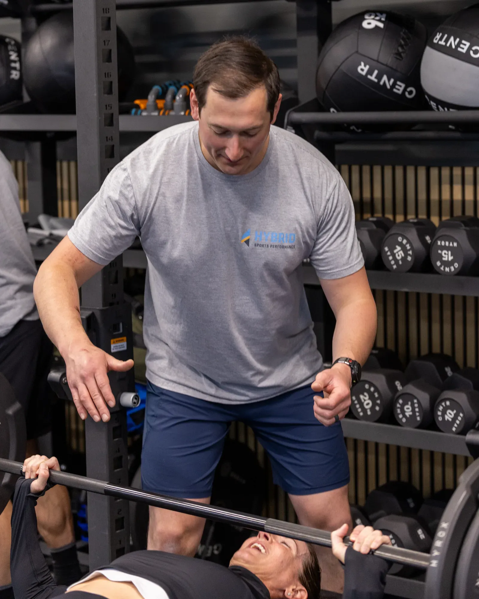 A Hybrid Sports Performance member asking a coach a question